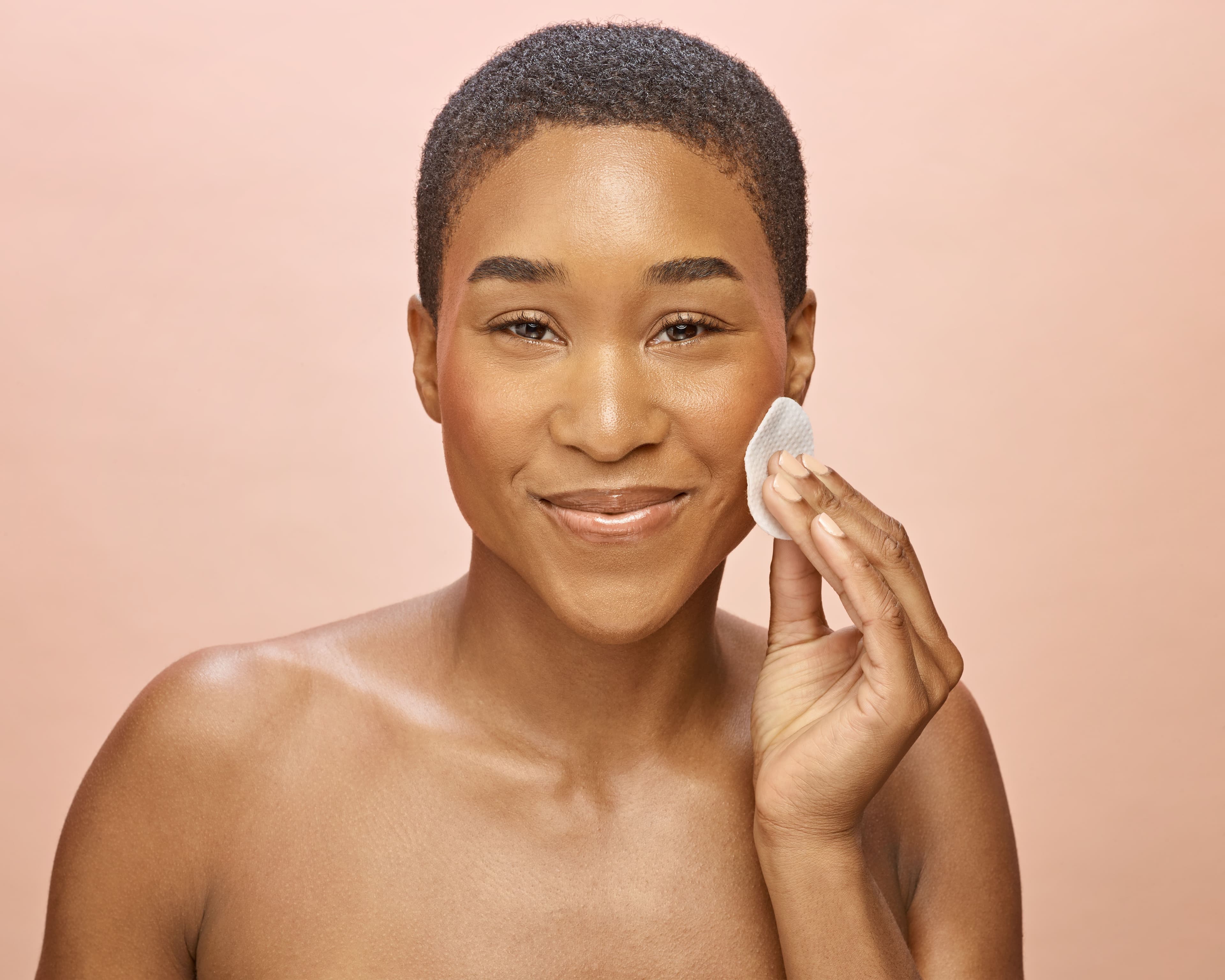 Applying a skincare product to left cheek